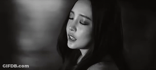 A Black And White Photo Of A Woman 'S Face With Her Eyes Closed . GIF