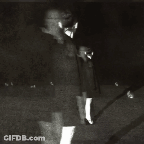 A Black And White Photo Of A Woman 'S Face With Her Mouth Open GIF