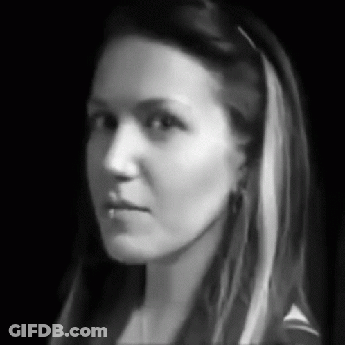 A Black And White Photo Of A Woman 'S Face With Long Hair GIF