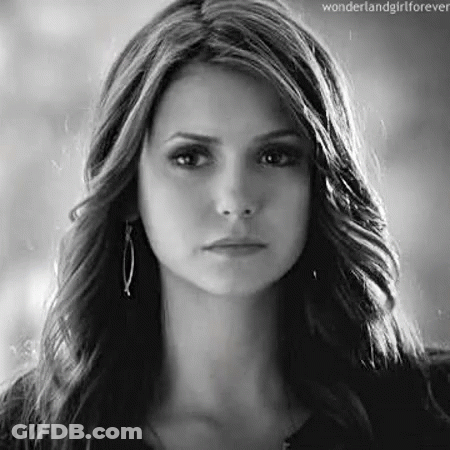 A Black And White Photo Of A Woman 'S Face With Long Hair . GIF