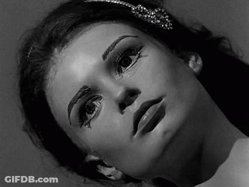 A Black And White Photo Of A Woman 'S Face With Makeup On Her Face . GIF