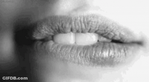 A Black And White Photo Of A Woman 'S Lips With Lipstick On Them . GIF