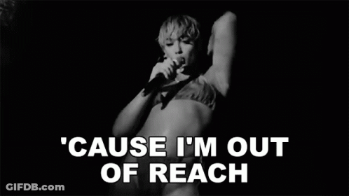 A Black And White Photo Of A Woman Singing Into A Microphone In A Bikini . GIF