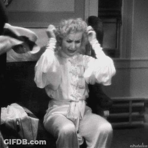 A Black And White Photo Of A Woman Sitting On A Chair With The Caption Nitratediva GIF