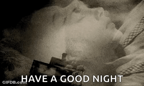 A Black And White Photo Of A Woman Sleeping In A Bed With The Words `` Have A Good Night '' Written Above Her . GIF