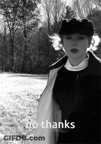 A Black And White Photo Of A Woman Standing In A Field With The Words No Thanks Written Below Her GIF