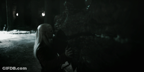 A Black And White Photo Of A Woman Standing In The Dark GIF