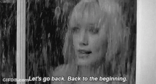 A Black And White Photo Of A Woman Standing In The Rain And Talking . GIF
