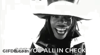 A Black And White Photo Of A Woman Wearing A Hat And Smiling With The Words `` Got You All In Check '' . GIF