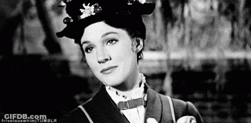 A Black And White Photo Of A Woman Wearing A Hat And Tie . GIF