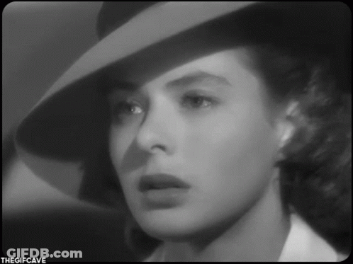 A Black And White Photo Of A Woman Wearing A Hat With The Gifcave Written On The Bottom GIF