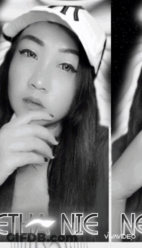 A Black And White Photo Of A Woman Wearing A Hat With The Word Ethan On The Bottom Right GIF