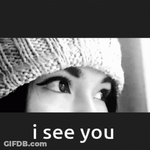 A Black And White Photo Of A Woman Wearing A Knitted Hat And The Words I See You Below Her GIF