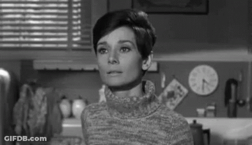 Black And White Photo Of Woman In Turtleneck Kitchen GIF