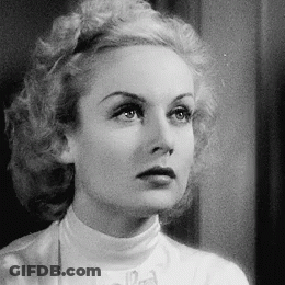 A Black And White Photo Of A Woman Wearing A White Turtleneck And A Bow Tie . GIF