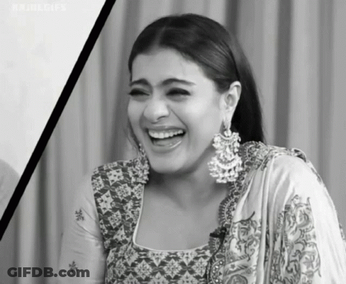 A Black And White Photo Of A Woman Wearing Earrings Laughing . GIF
