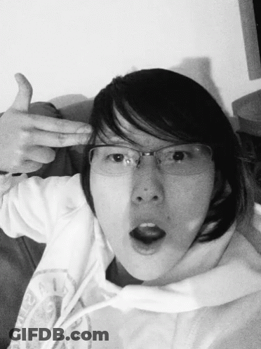 A Black And White Photo Of A Woman Wearing Glasses And A Hoodie GIF