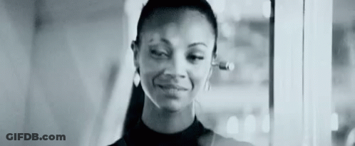 A Black And White Photo Of A Woman Wearing Headphones . GIF