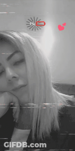 A Black And White Photo Of A Woman With A Clock Behind Her That Says 1% On It GIF