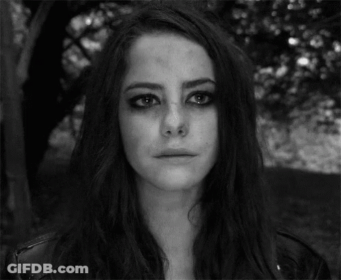 A Black And White Photo Of A Woman With A Crying Face . GIF