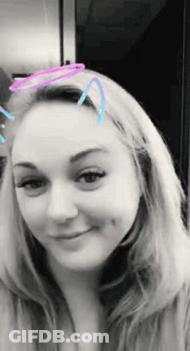 A Black And White Photo Of A Woman With A Filter On Her Face GIF