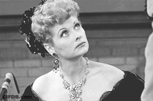 A Black And White Photo Of A Woman With A Necklace GIF