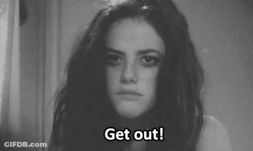 A Black And White Photo Of A Woman With A Sad Look On Her Face . GIF