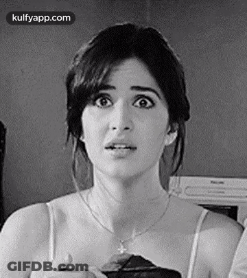 A Black And White Photo Of A Woman With A Surprised Look On Her Face And A Necklace . GIF