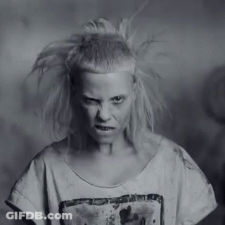 A Black And White Photo Of A Woman With A Very Strange Haircut . GIF