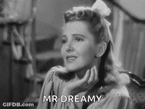 A Black And White Photo Of A Woman With A White Bow In Her Hair . GIF