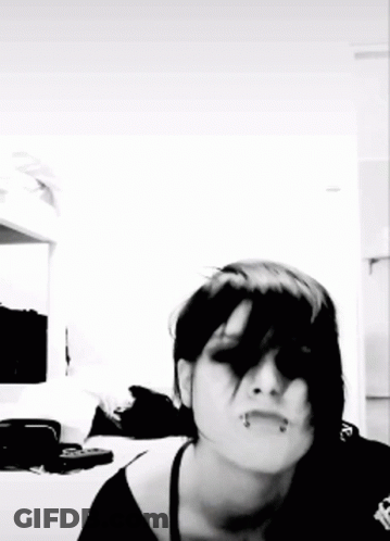 A Black And White Photo Of A Woman With Dark Hair GIF