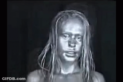 A Black And White Photo Of A Woman With Dreadlocks And A Dirty Face . GIF