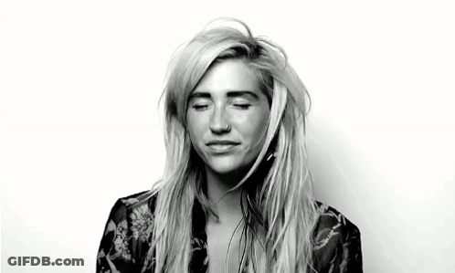 A Black And White Photo Of A Woman With Her Eyes Closed And A Nose Piercing . GIF