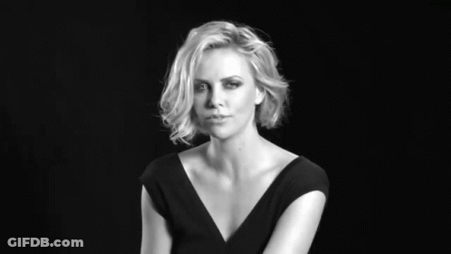 A Black And White Photo Of A Woman With Her Hand On Her Face GIF
