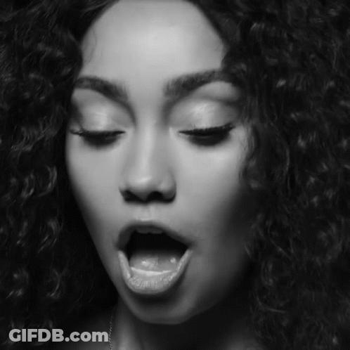 A Black And White Photo Of A Woman With Her Mouth Open And Her Tongue Sticking Out GIF