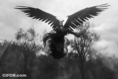 A Black And White Photo Of A Woman With Large Wings Flying In The Air . GIF
