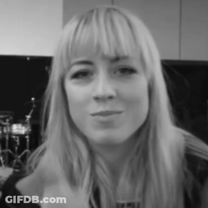 A Black And White Photo Of A Woman With Long Blonde Hair GIF