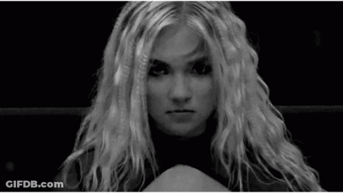 A Black And White Photo Of A Woman With Long Blonde Hair Making A Funny Face . GIF