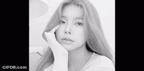 A Black And White Photo Of A Woman With Long Blonde Hair Taking A Selfie . GIF