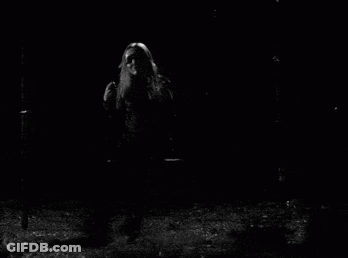 A Black And White Photo Of A Woman With Long Hair GIF