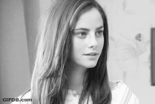 A Black And White Photo Of A Woman With Long Hair . GIF