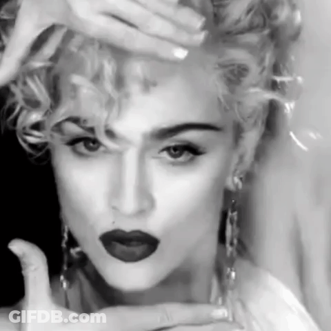 A Black And White Photo Of A Woman With Red Lipstick And Curly Hair . GIF