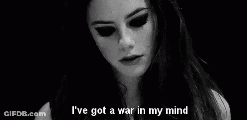 A Black And White Photo Of A Woman With The Words `` I 'Ve Got A War In My Mind '' Written On It . GIF