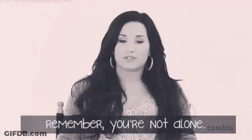 A Black And White Photo Of A Woman With The Words " Remember You 'Re Not Alone " Below Her GIF