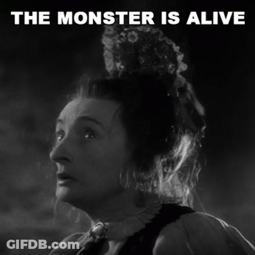 A Black And White Photo Of A Woman With The Words The Monster Is Alive Above Her GIF