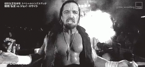 A Black And White Photo Of A Wrestler With Foreign Writing On The Bottom GIF