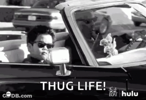 A Black And White Photo Of A Young Boy Driving A Car With The Words `` Thug Life '' Written On It . GIF