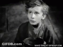 A Black And White Photo Of A Young Boy Holding A Bowl GIF