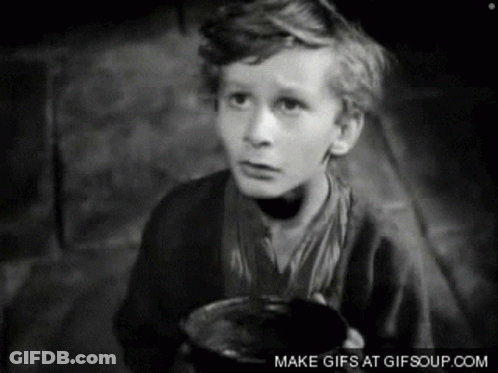 A Black And White Photo Of A Young Boy Holding A Cup GIF