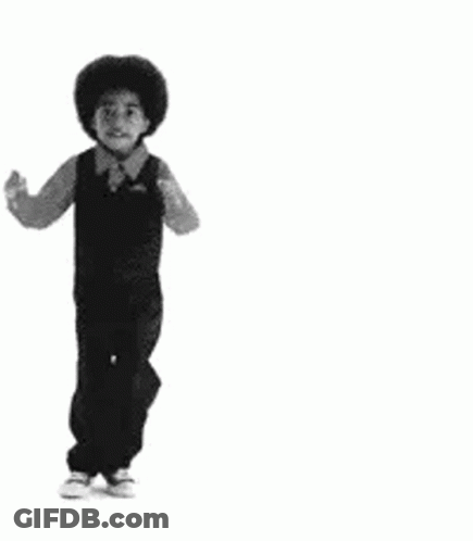 A Black And White Photo Of A Young Boy In Overalls Dancing . GIF